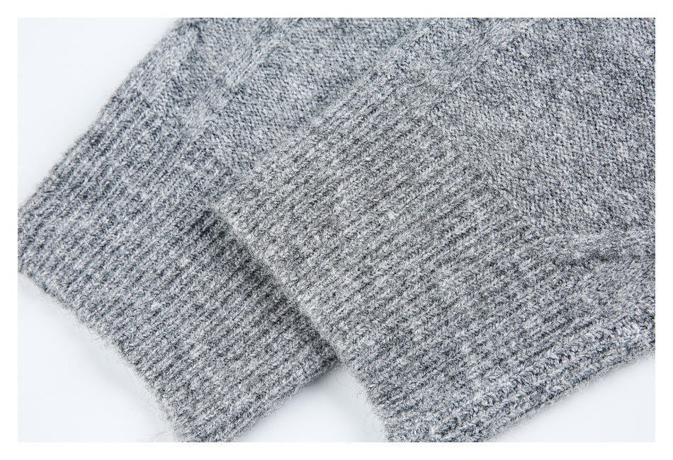 Close-up of a heather gray knitted garment showing a wide ribbed cuff or hem.
