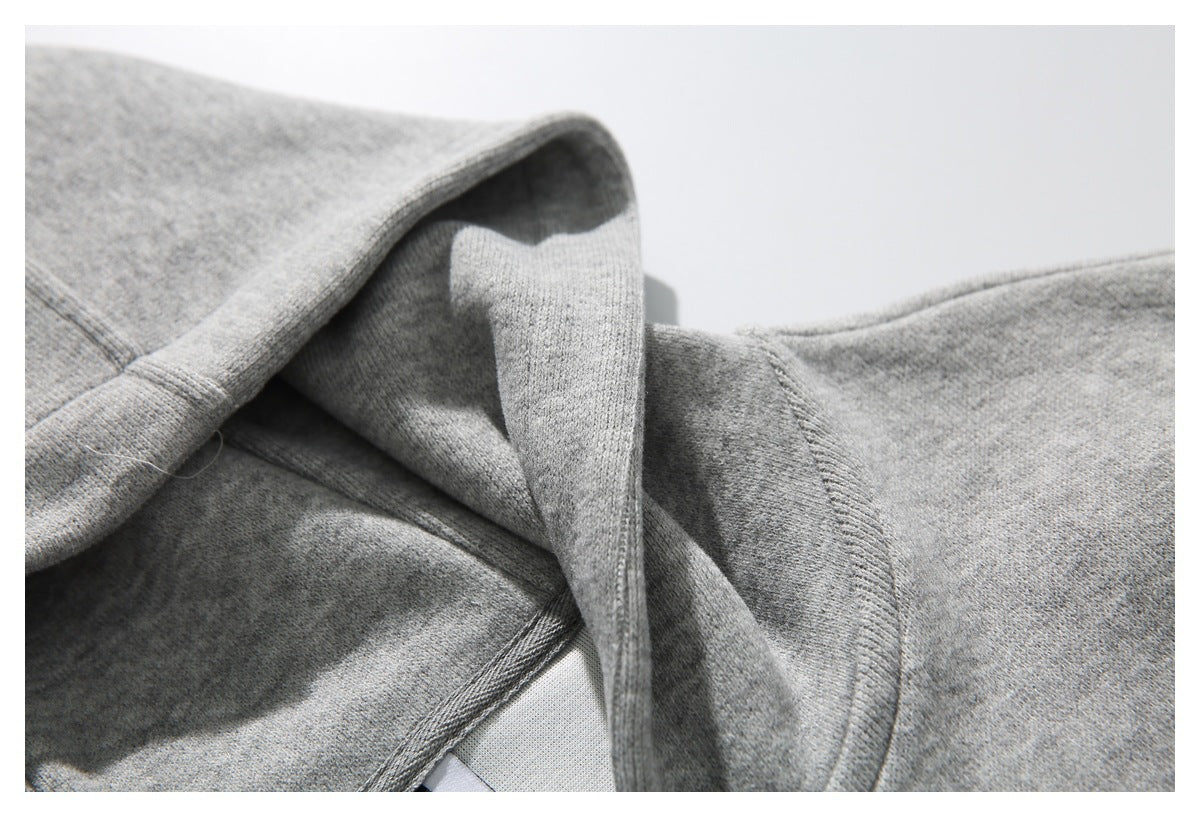 Close-up of the light gray hoodie's hood and shoulder seam.