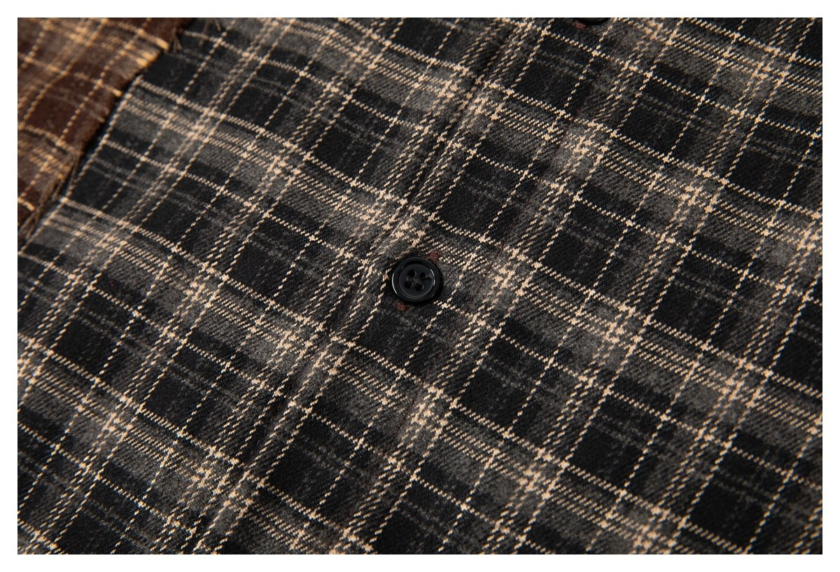 Close-up of charcoal plaid shirt fabric and a black button.