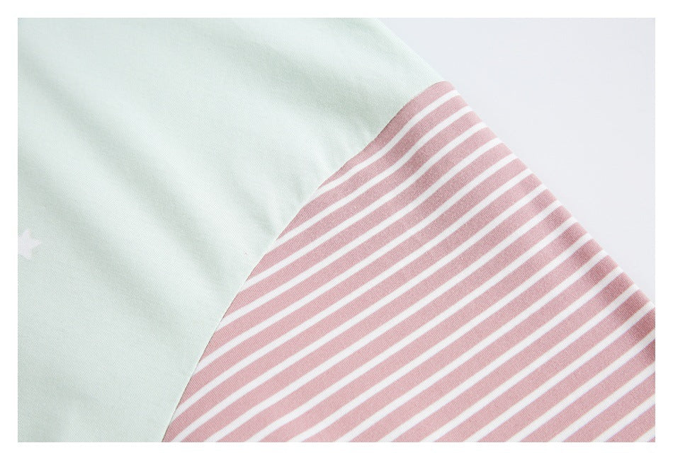 Close-up showing pale mint fabric beside a dusty pink-and-white striped panel.
