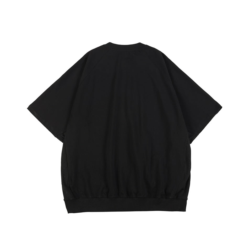 Back view of a plain black oversized short-sleeve top with raglan seams and a ribbed hem.