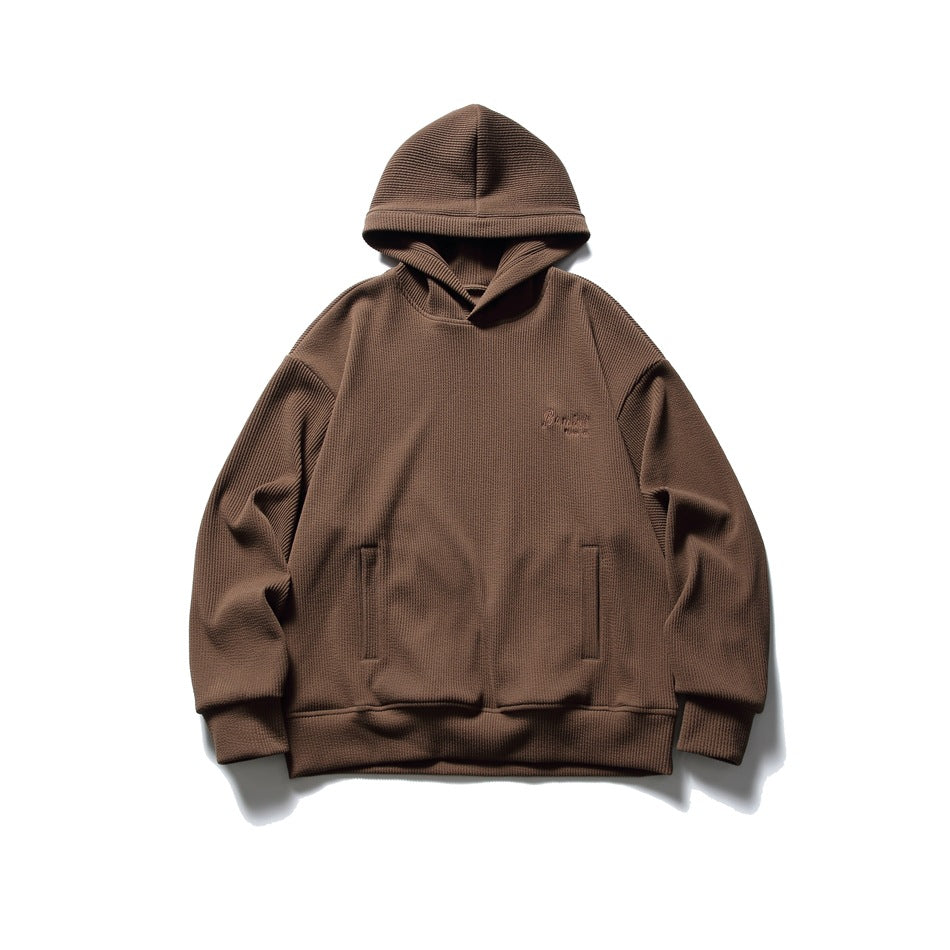 Brown waffle-knit pullover hoodie flat lay, front view with slit pockets and small chest embroidery