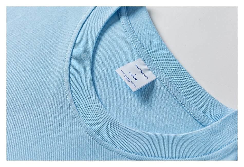 Close-up of the light blue T-shirt's ribbed crew neck and interior label marked Made in China.