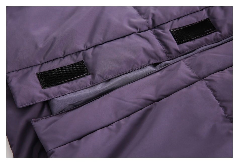 Close-up of a dark purple padded garment with stitched panels and two black hook-and-loop tabs.