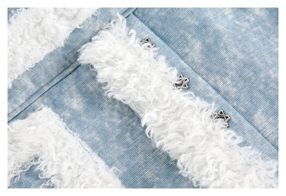 Close-up of blue jacket fabric, white fleece trim, and small silver star-shaped front fasteners.