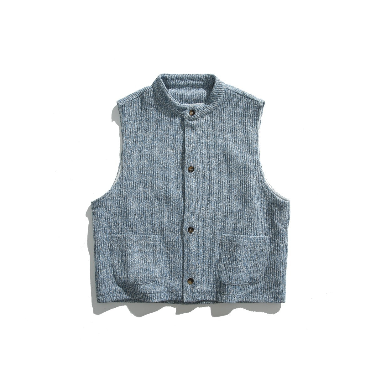 Light blue ribbed knit-look vest with stand collar, four buttons and two patch pockets, flat lay on white