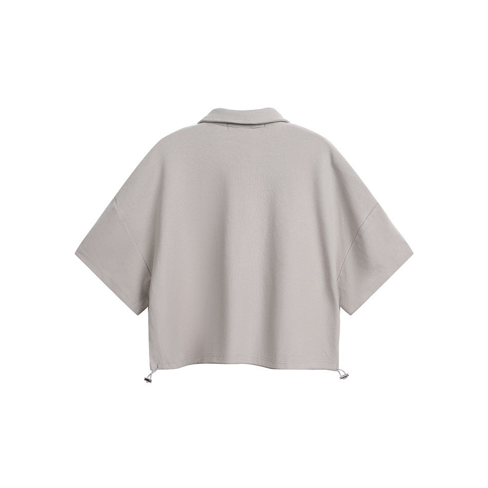 Back view of a light gray short-sleeve collared top with a relaxed cut and adjustable drawcord hem.