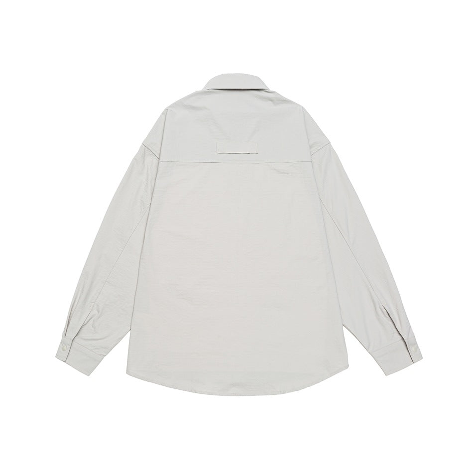 Back view of an off-white long-sleeve overshirt laid flat, with a collar, yoke seam, and button cuffs.