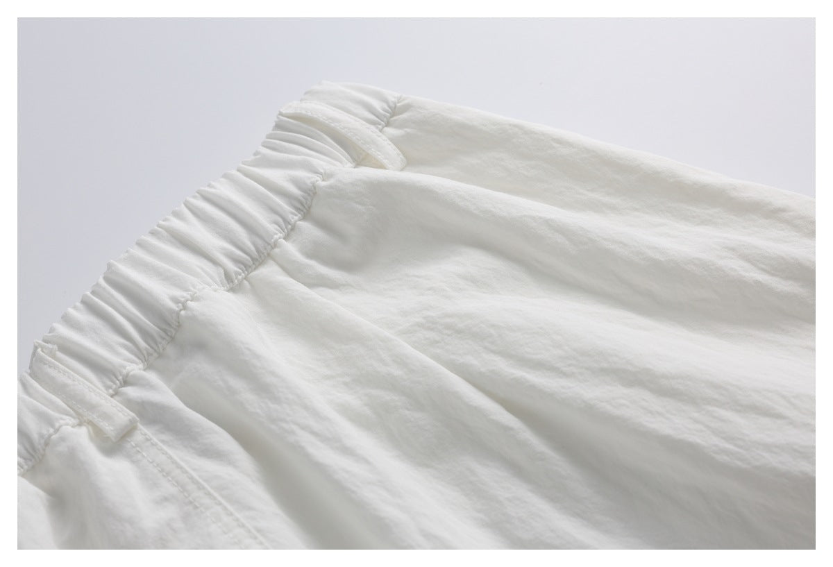 Close-up of the white shorts’ gathered elastic waistband and belt loops.