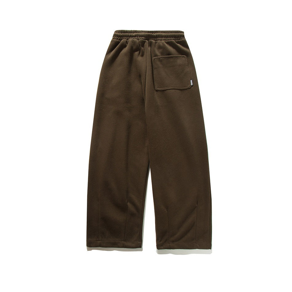 Back view of dark brown wide-leg sweatpants with an elastic waistband and a square patch pocket.