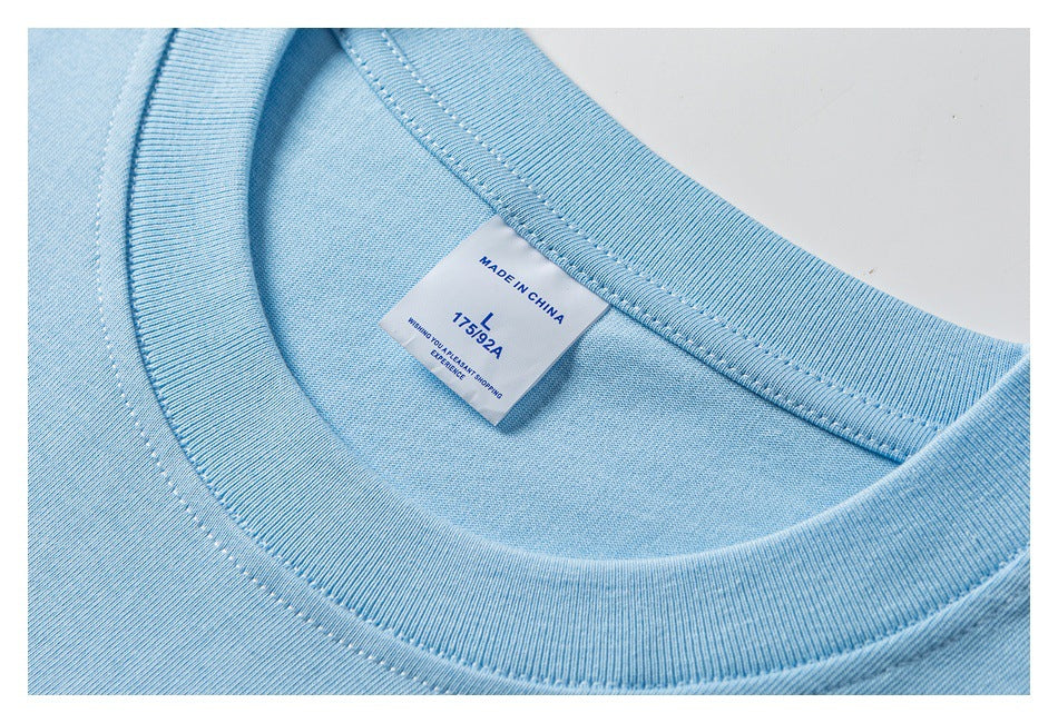 Close-up of a light blue T-shirt neckline and inner label marked “Made in China” and size L.