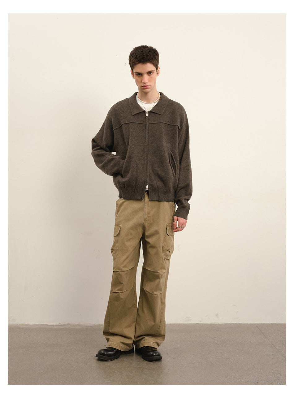 Model wearing a dark gray-brown zip cardigan with a collar and khaki cargo pants.
