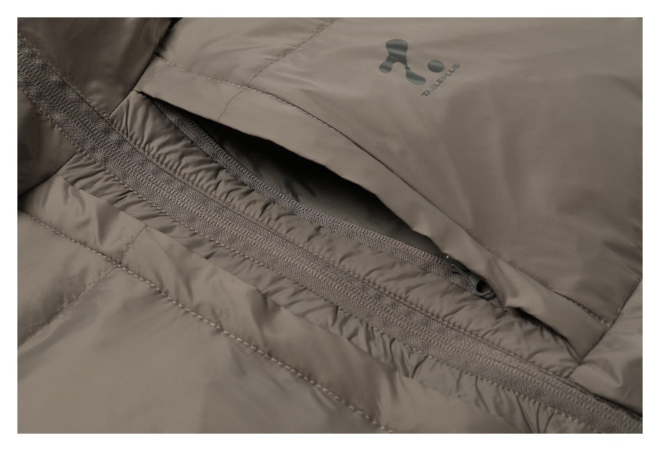 Close-up of a taupe jacket zipper pocket with a small logo printed above it.
