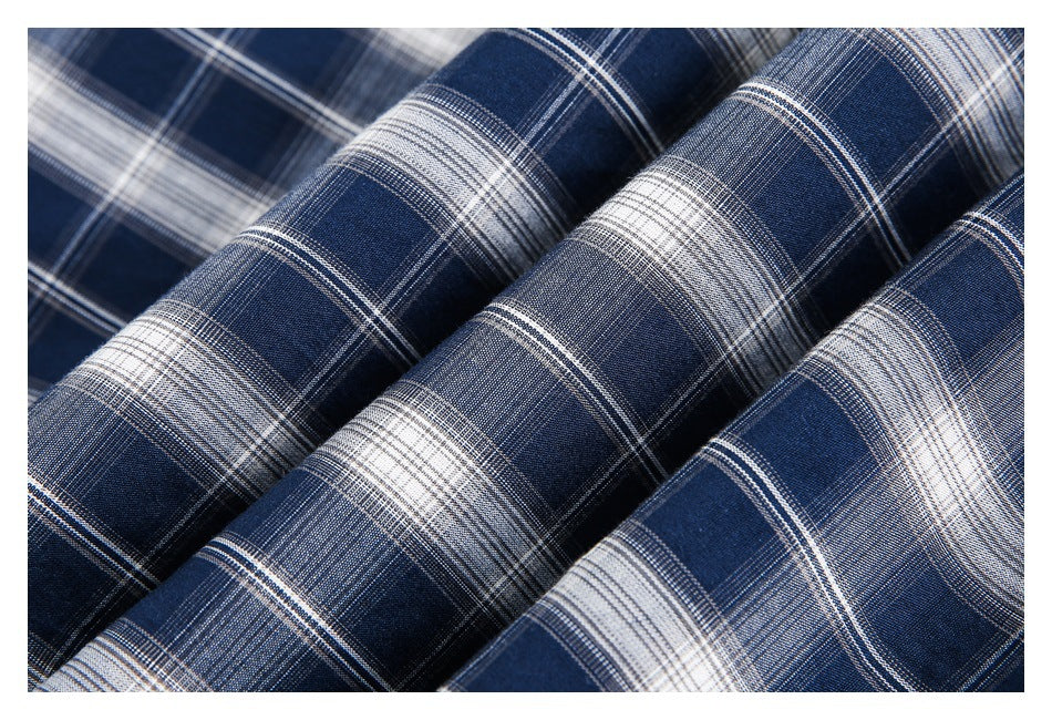 Close-up of navy and white plaid fabric arranged in soft folds.