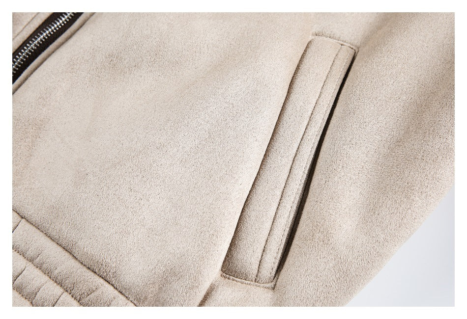 Close-up of a beige jacket with a narrow zippered opening and a vertical welt pocket.