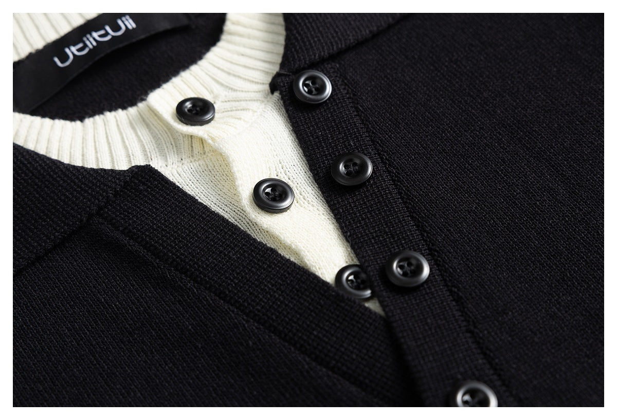 Close-up of the black cardigan's button placket, black buttons, and cream ribbed neckline.