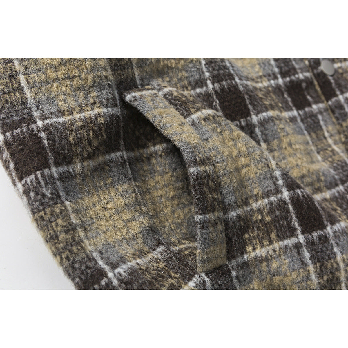 Close-up of a plaid jacket pocket and seam in muted brown, gray, and cream checks.