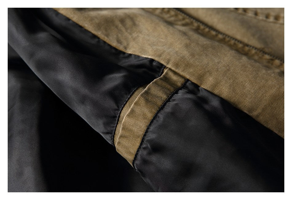 Close-up of the tan-brown jacket exterior meeting its black lining at a stitched seam.