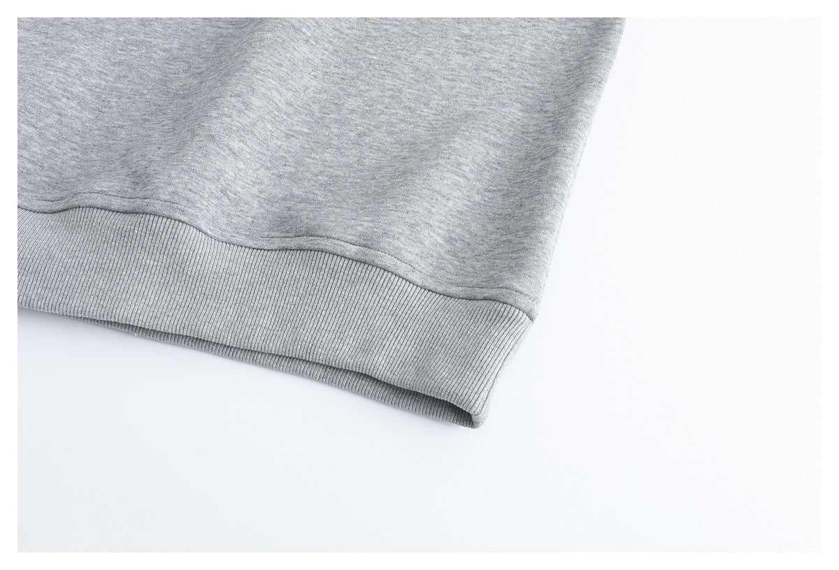Close-up of the light gray top's ribbed bottom hem.
