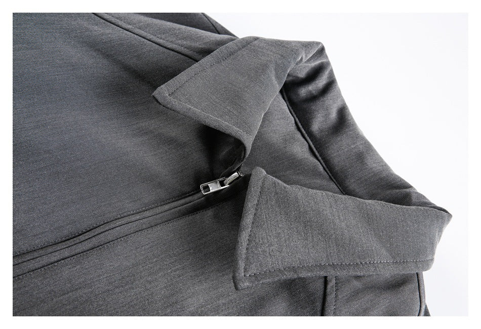 Close-up of the gray jacket's lapel, front zipper, and stitching.