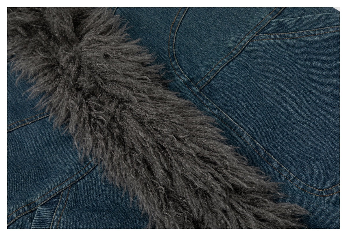 Close-up of gray shaggy trim against blue denim jacket panels and stitching.