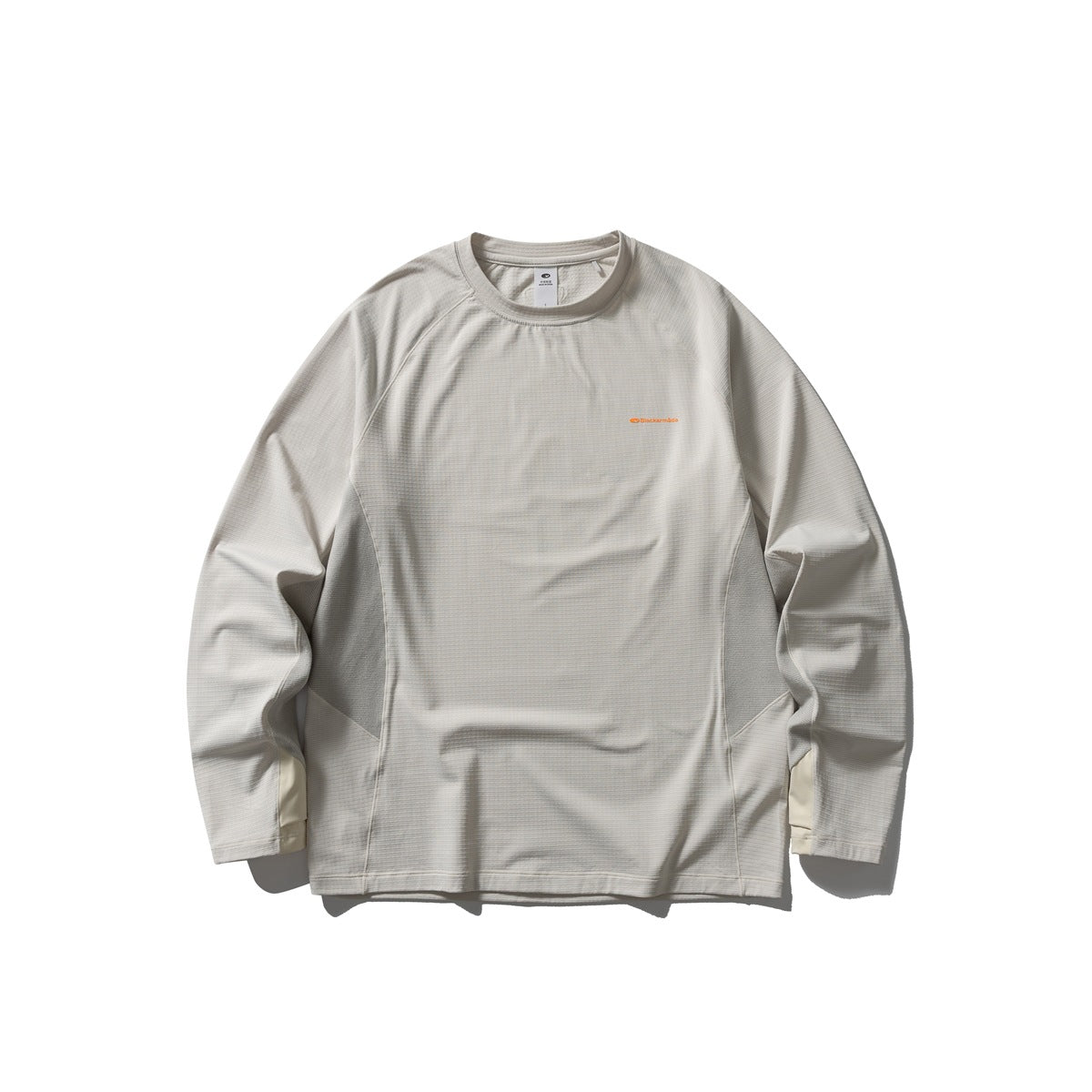 Oat beige long-sleeve crew-neck top with raglan sleeves, gray side panels and a small orange chest print, flat front view