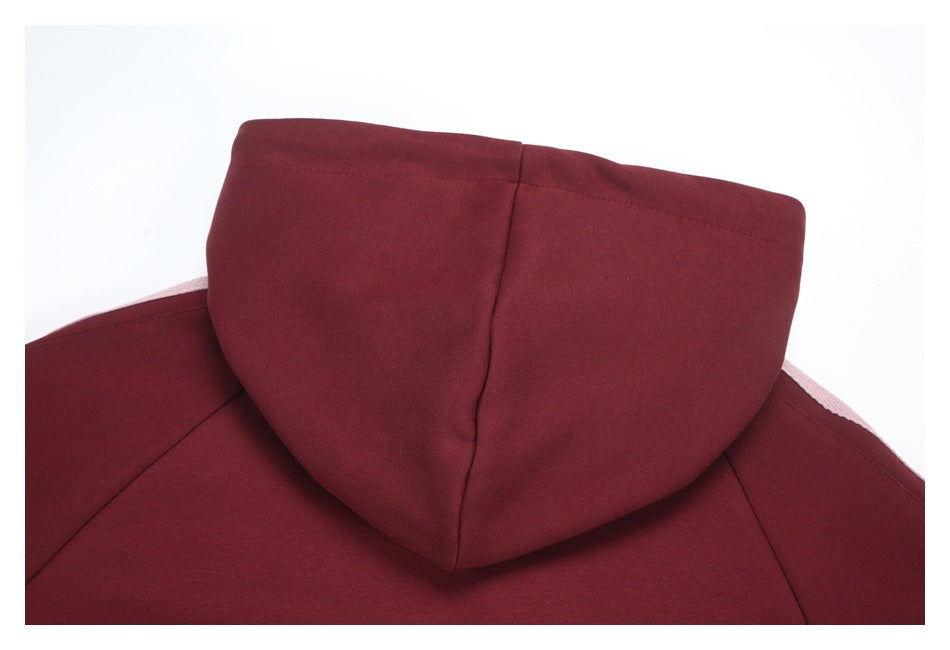Close-up of the burgundy hoodie’s hood and center seam, laid flat against a white background.