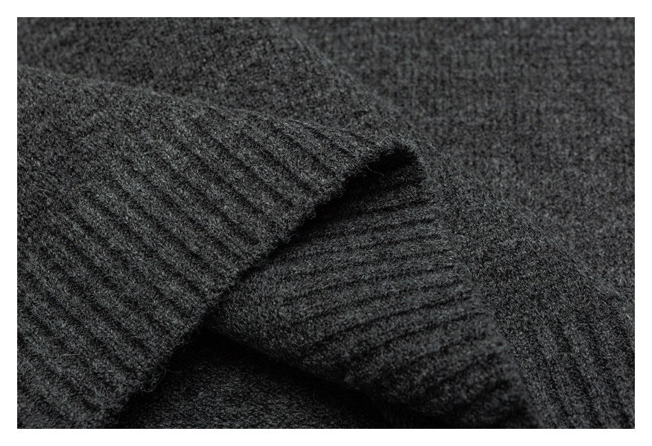 Close-up of dark charcoal knit fabric with a folded, ribbed edge.