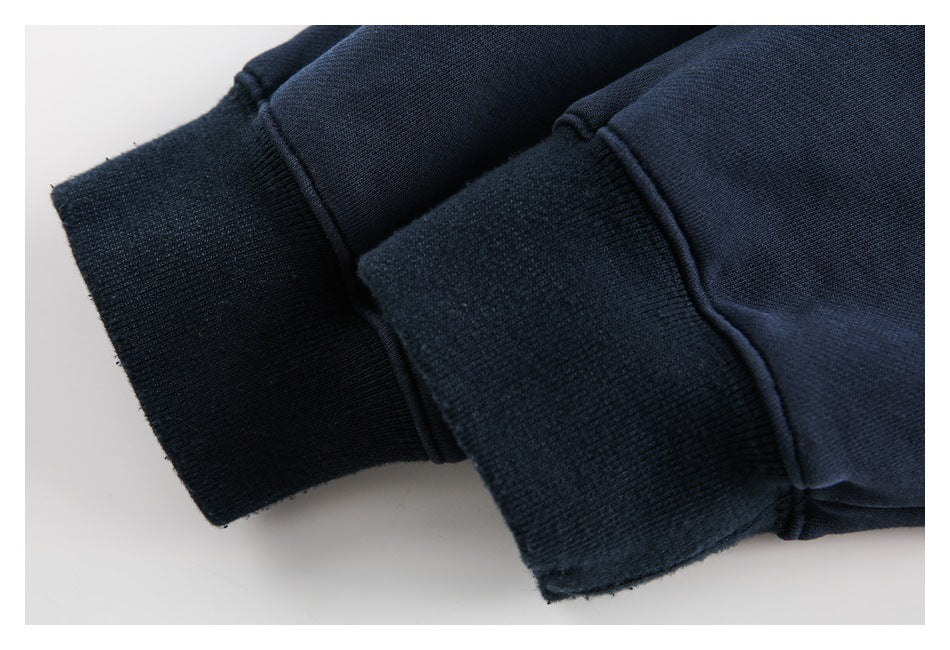 Close-up of two dark navy garment cuffs showing ribbed edges and stitching.