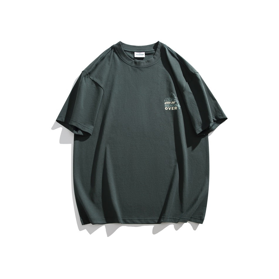 Dark green oversized crew-neck T-shirt with short sleeves and a small multicolor graphic on the left chest.