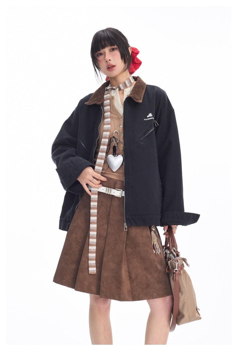 Closer view of a model wearing a dark navy jacket with a brown collar and a brown flared skirt.