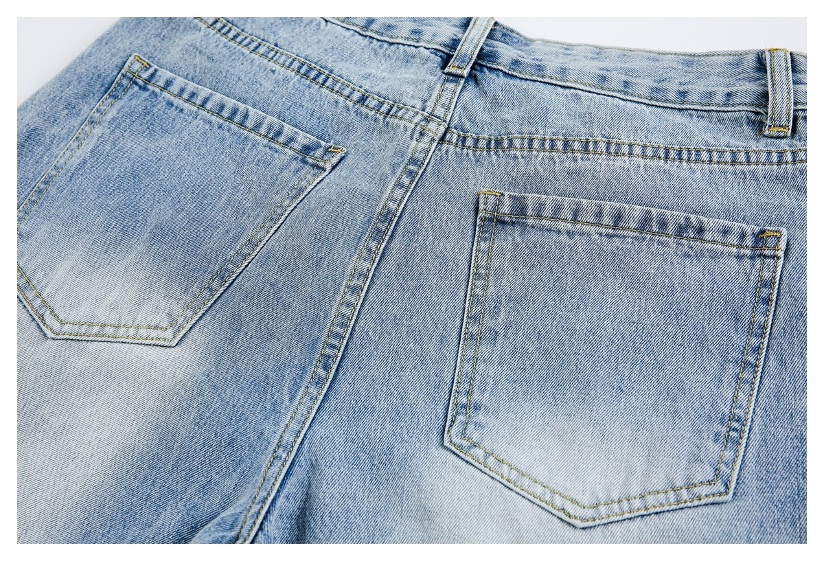 Close-up of the back of light blue jeans, showing two patch pockets, belt loops, and yellow stitching.