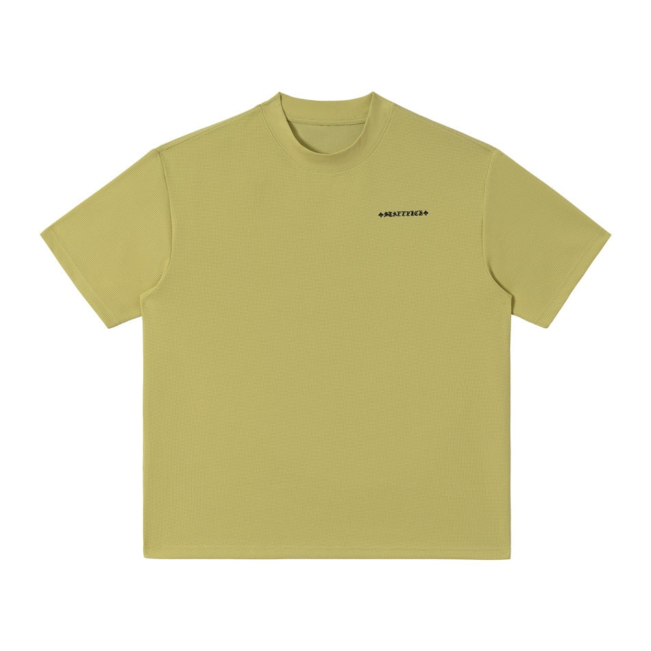 Green waffle-textured short-sleeve T-shirt, front view with small dark lettering on the left chest