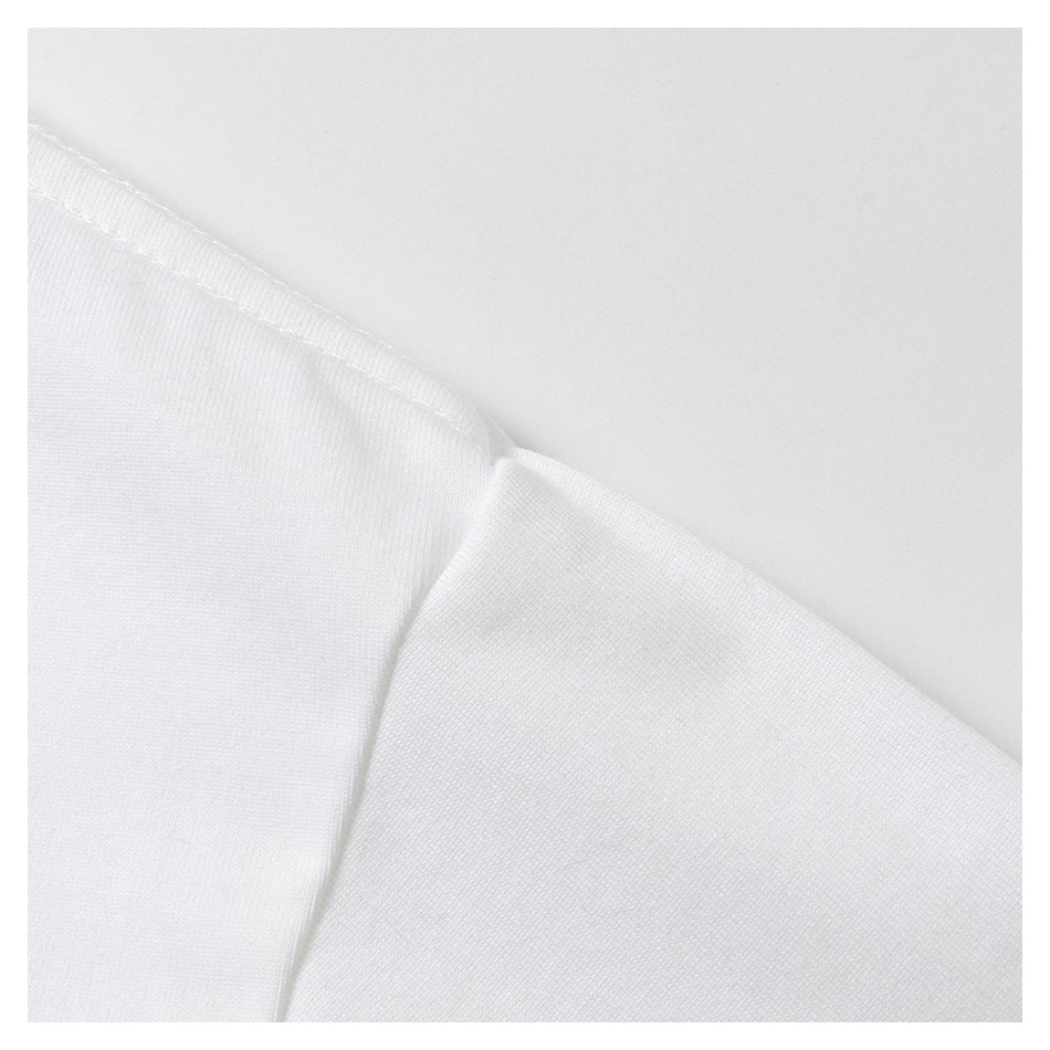 Close-up of white fabric with a stitched edge and overlapping layers.