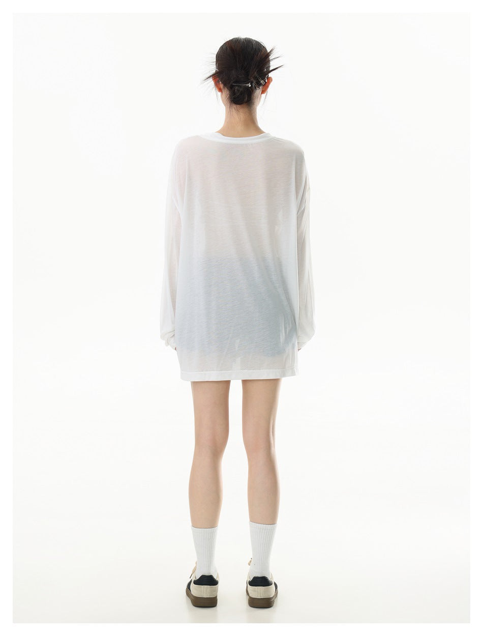 Back view of a model wearing an oversized sheer white long-sleeve tee with a plain back.