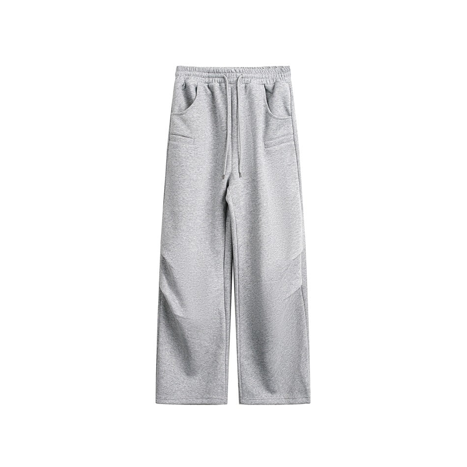 Heather gray drawstring sweatpants with wide straight legs and slanted pockets, flat front view on white