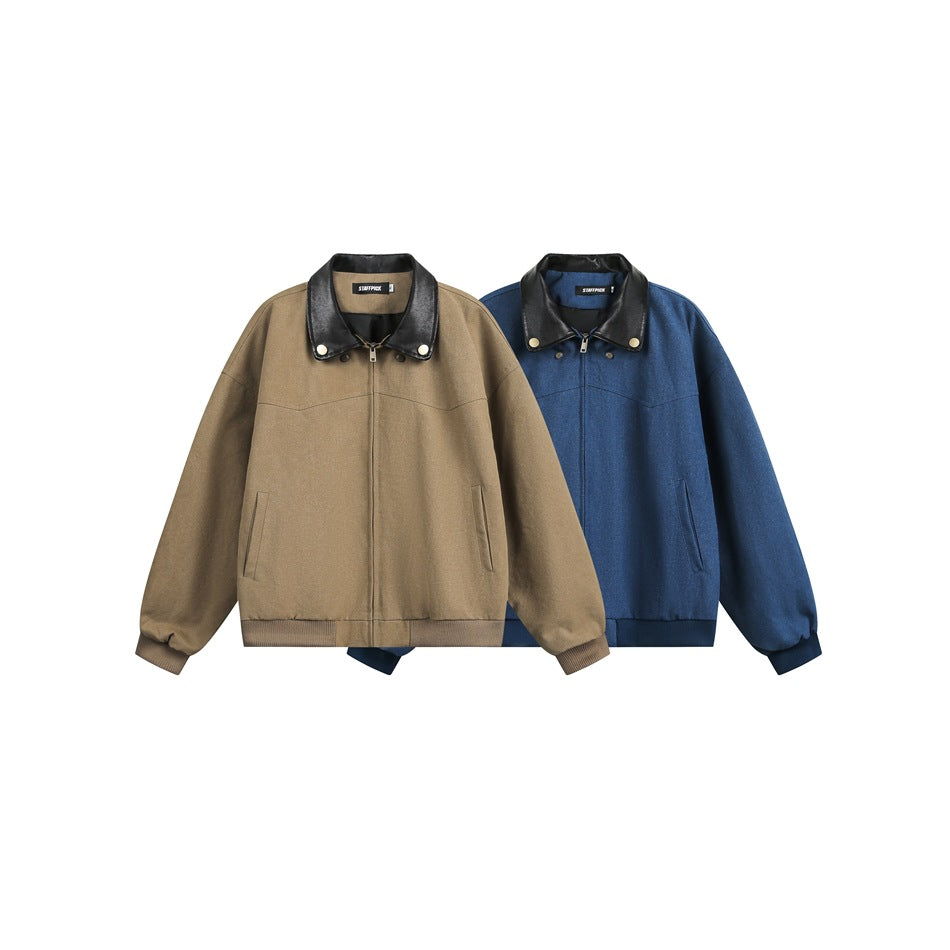 Front view of tan and blue zip-up jackets with black collars, snap details, side pockets, and ribbed hems.