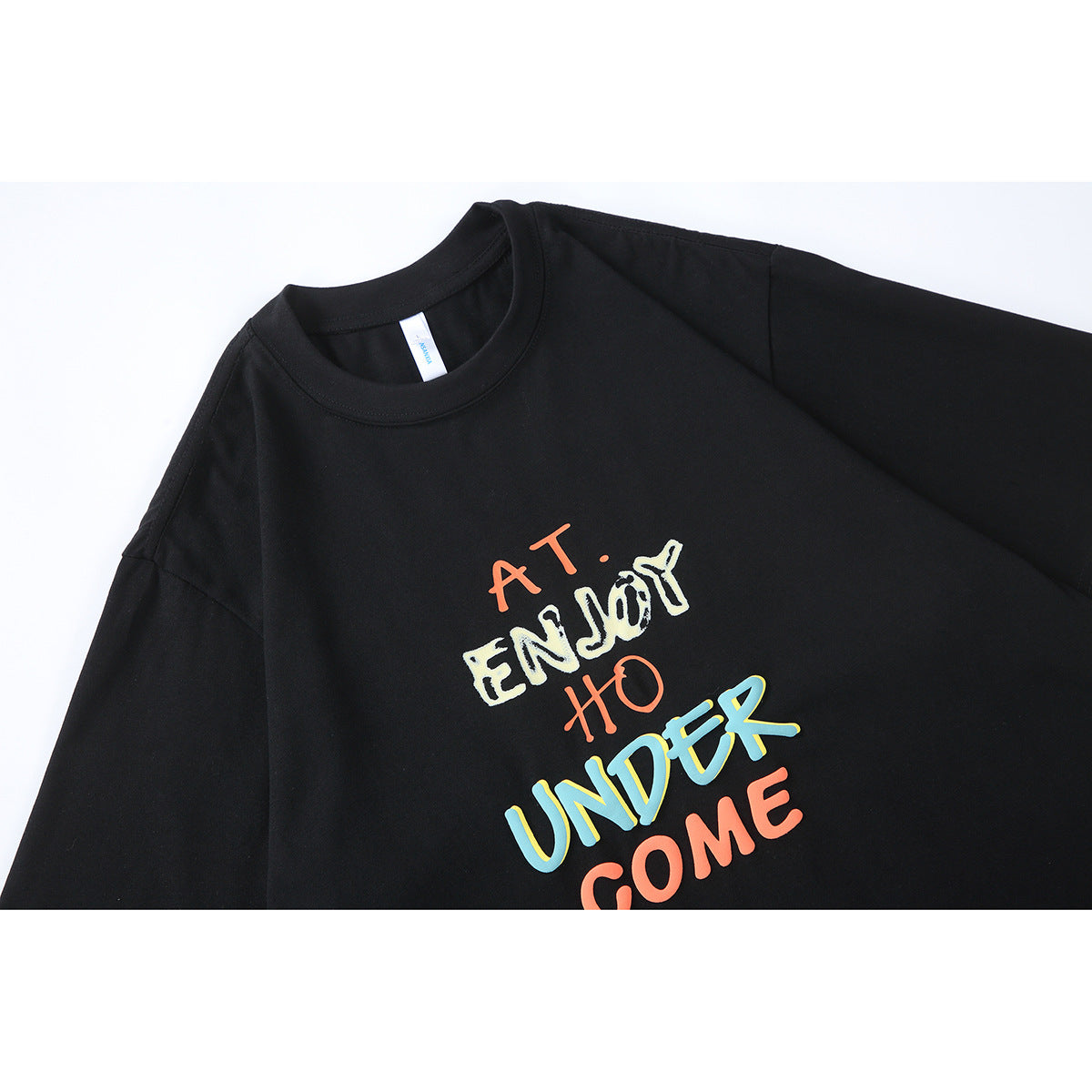 Close-up of a black crew-neck T-shirt with colorful, stacked lettering on the chest.