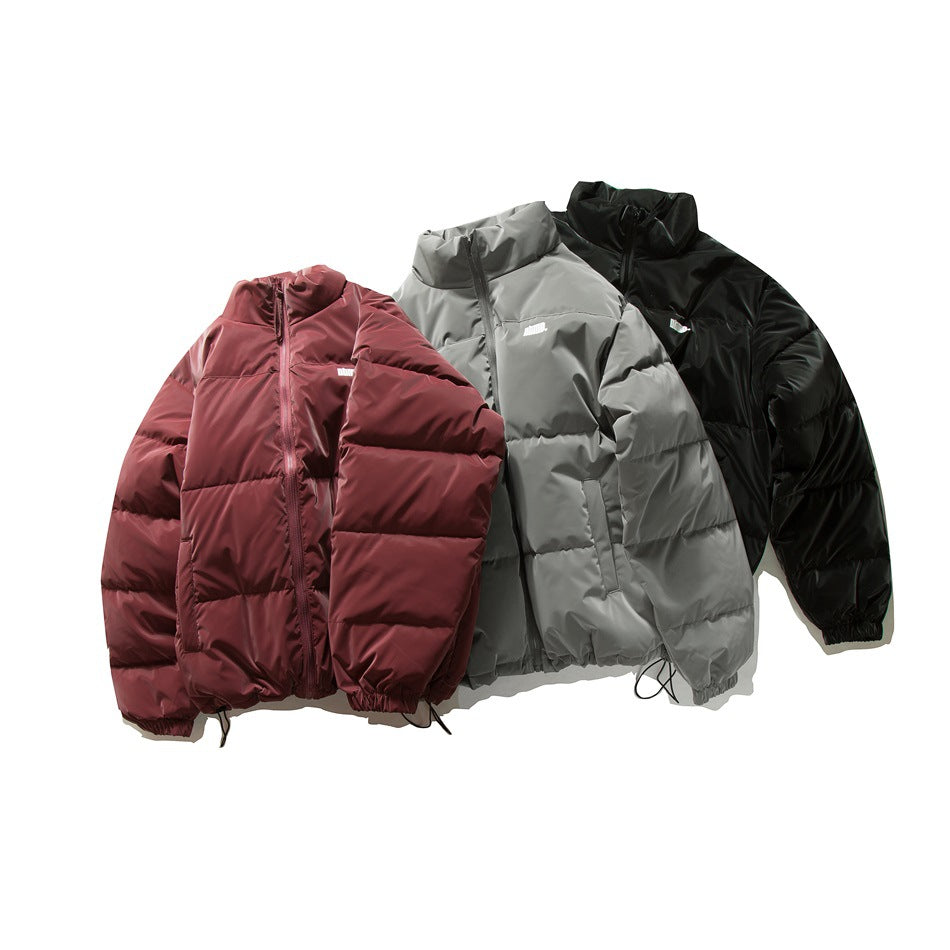 Three front-facing puffer jackets in burgundy, gray and black, each with a high collar and horizontal quilting.