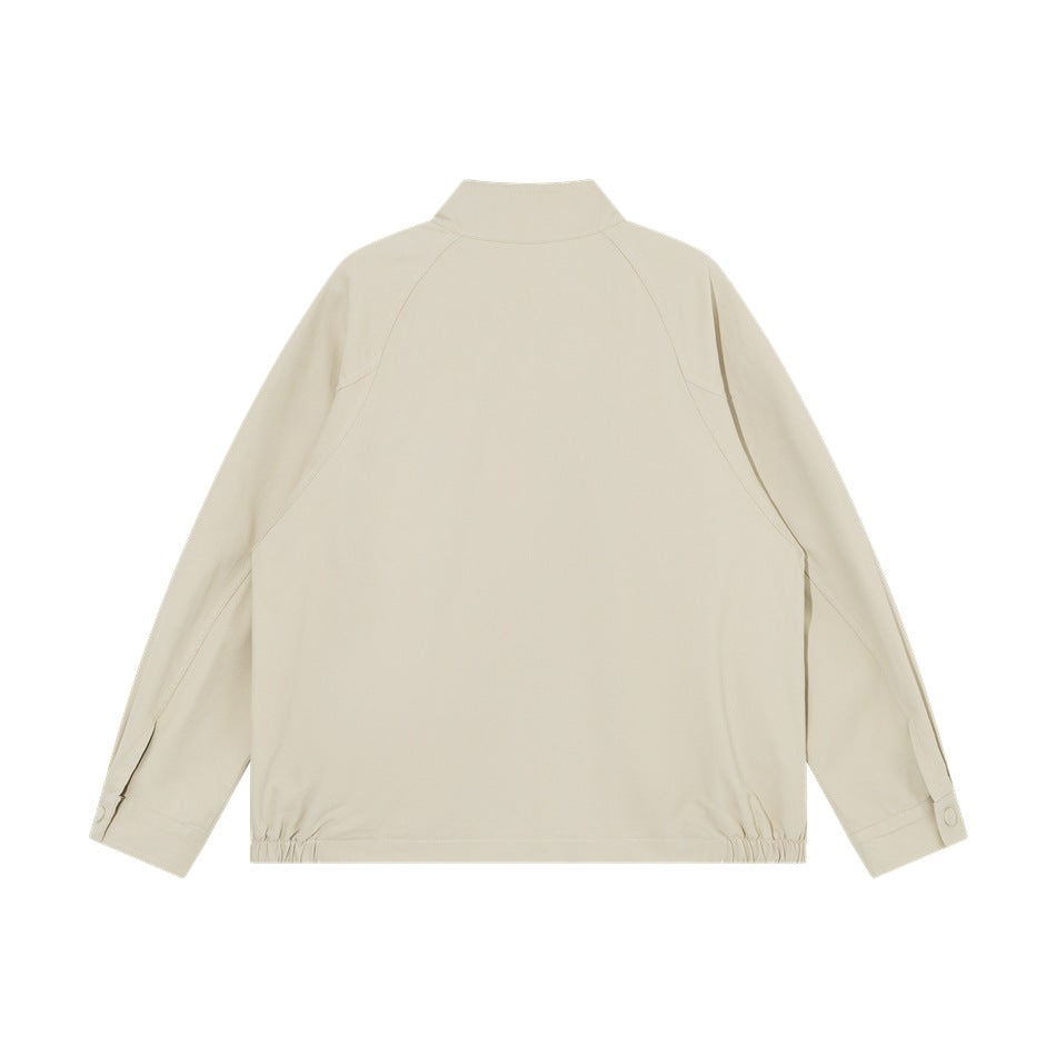 Back view of an ivory jacket with a stand collar, raglan sleeves, and elasticized hem.