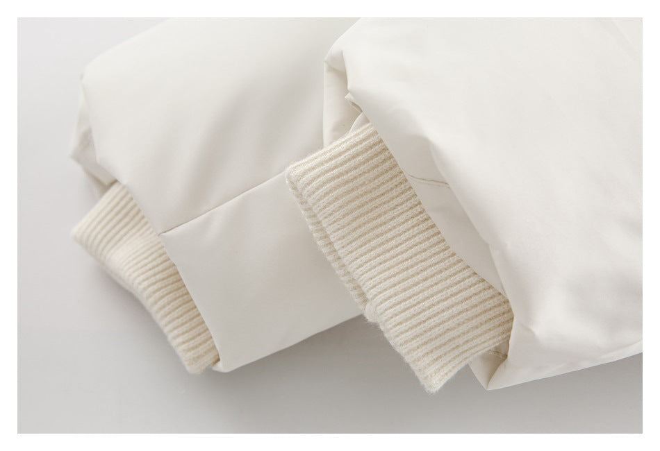 Close-up of an off-white garment with ribbed knit cuffs or trim beside smooth fabric panels.