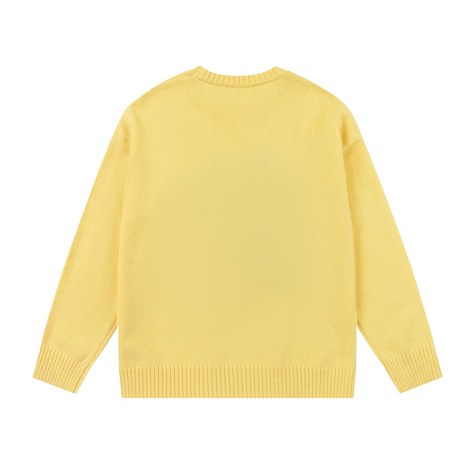 Back view of a plain pale yellow crewneck sweater with long sleeves and ribbed neckline, cuffs, and hem.