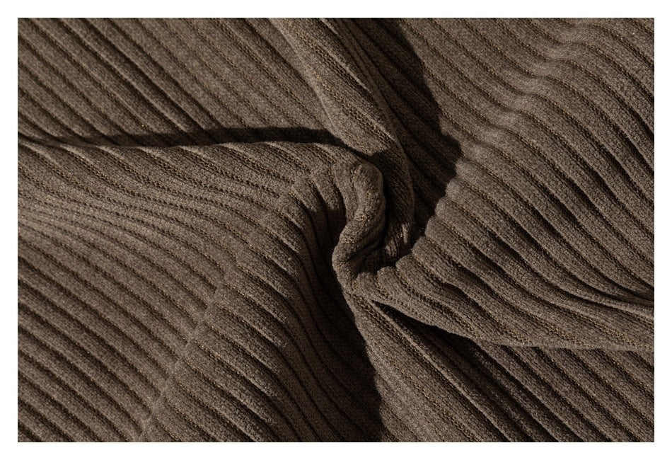 Close-up of brown ribbed garment fabric gathered into folds.