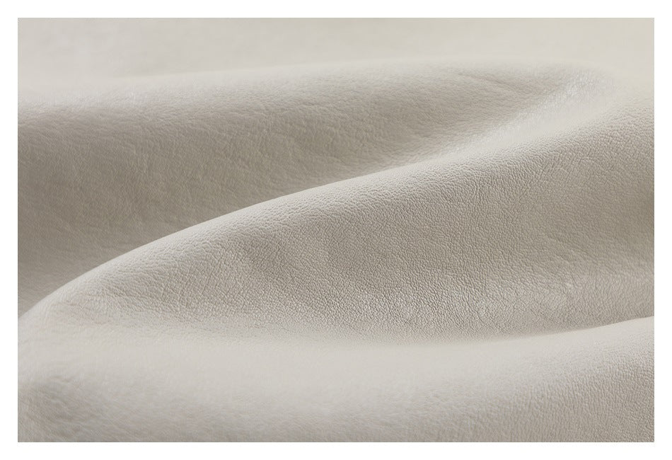 Macro view of the light beige jacket's softly textured surface.