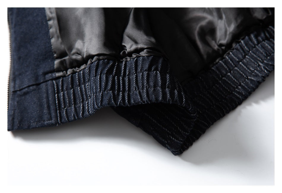 Close-up of the jacket's dark lining and gathered elastic hem, shown from the inside.
