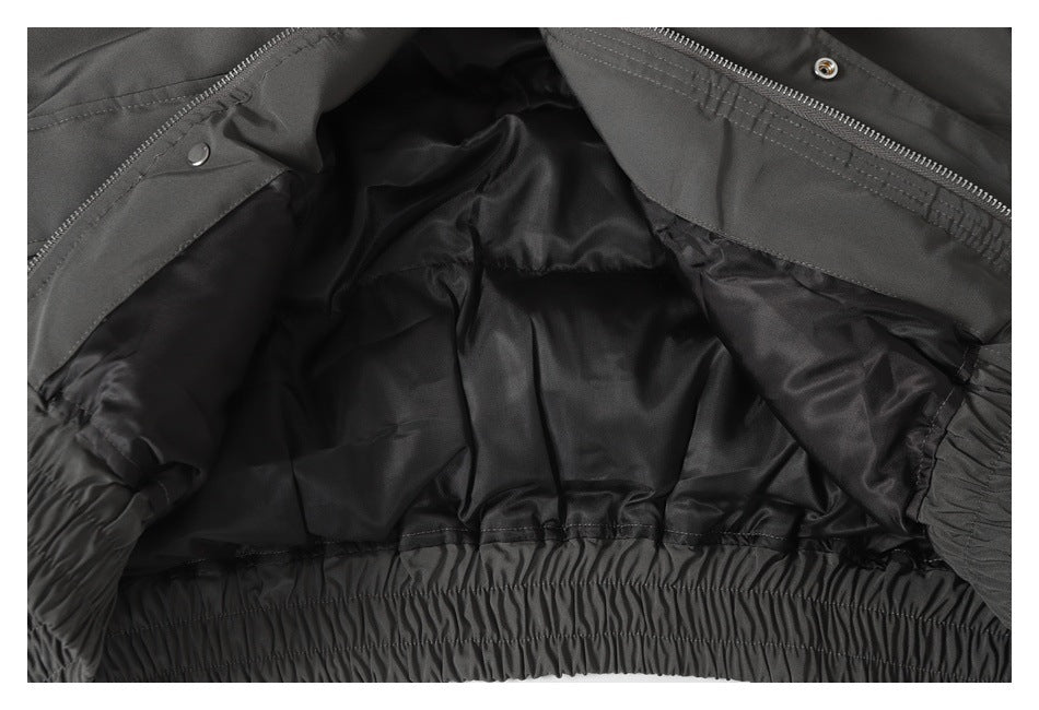 Close-up of the jacket opened to show its dark lining and gathered elastic hem.