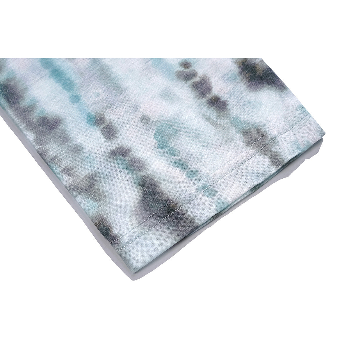 Close-up of the double-stitched sleeve hem on a pale blue-gray tie-dye top.