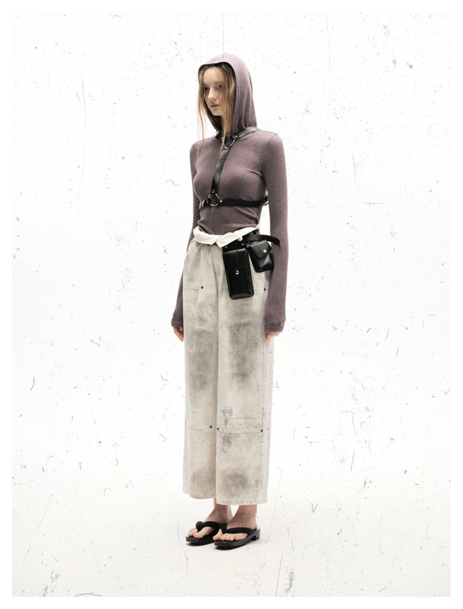 Full-length model wearing off-white wide-leg trousers with gray distressed marks and visible front panel seams.
