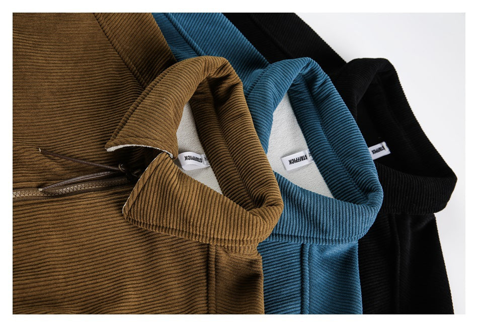 Close-up of black, blue, and brown jackets arranged together, showing their collars, ribbed texture, and inner labels.