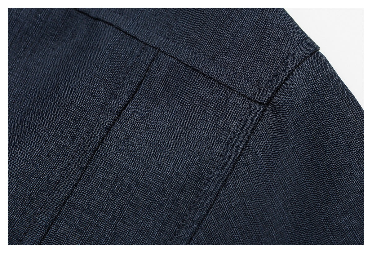 Close-up of stitched panel seams on a dark navy garment.